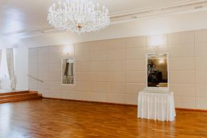 a large room with a table and a chandelier at Hotel Kruk in Smardzewice