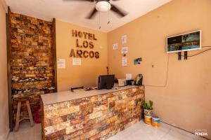 a hotel los angeles salon with a brick wall at Hotel los Arcos in Izamal