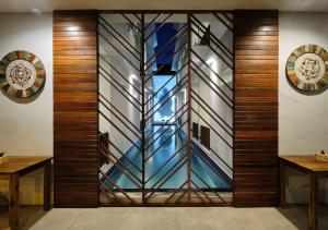 a lobby with a wall with a stained glass window at Gili Kama Hotel & Villa in Gili Trawangan