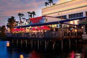a restaurant with tables and umbrellas on a pier at Golden Nugget Laughlin in Laughlin