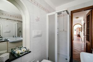 a bathroom with a toilet and a sink and a mirror at Villa Fantastica in Carate Urio +21 photos