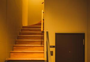 a staircase with wooden steps in a building at Seacruise House Navio in Kami Amakusa