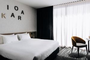 a hotel room with a clock on the wall at Novotel Melbourne South Wharf in Melbourne
