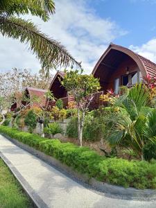 a house with a garden in front of it at Bamboo Bungalow Jungle View in Nusa Penida