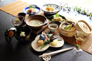 a table with plates of food and bowls of food at Nanten-En in Kawachinagano