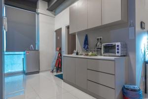 a kitchen with a counter with a microwave on it at Cozy Home with Spectacular View in Bayan Lepas