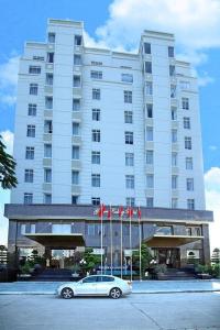 a car parked in front of a large building at Golden Halong Hotel in Ha Long