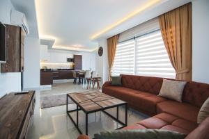 a living room with a couch and a table at Elite Marine Residence apartment in Alanya