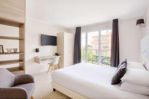 a hotel room with a bed and a window at Best Western Plus Antibes Riviera in Antibes