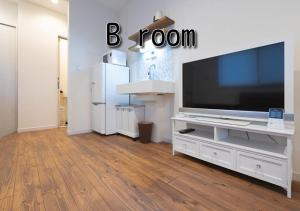 a living room with a large television on a white entertainment center at FLAG Zushi in Zushi