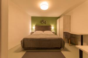 a bedroom with a large bed and a desk at Apartment Adriatico Eterno 2 in Rovinj