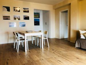 a dining room with a white table and chairs at Taliari Taormina Apartment in Taormina +24 photos