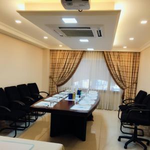 a conference room with a long table and chairs at Comfort Hotel Suites in Amman
