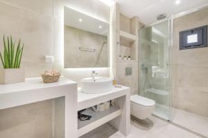 a bathroom with a sink and a toilet and a shower at Stylish & Bright Apartment in the City Centre in Zakynthos