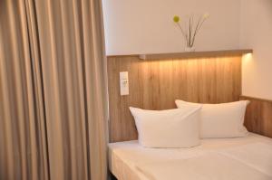Postel nebo postele na pokoji v ubytování Hotel Perlach Allee by Blattl