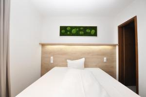 Postel nebo postele na pokoji v ubytování Hotel Perlach Allee by Blattl