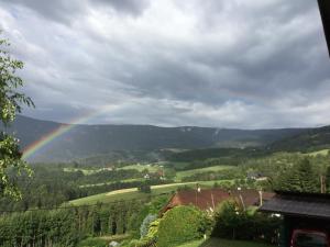 a rainbow in the sky over a valley at Ferienwohnung Zapfl Maria in Greisdorf