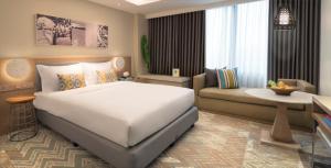 Postel nebo postele na pokoji v ubytování Citadines Cebu City