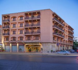 a large building with a car parked in front of it at Civitel Akali Hotel in Chania