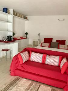 a bedroom with a red bed with a red blanket at Chez Madame de Bellecour in Lyon