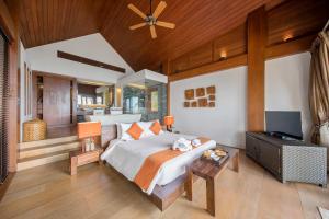 a bedroom with a bed and a flat screen tv at Baan Hinta in Lamai