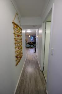 a living room with a door open to a hallway at Sanctuary Beach Retreat in Gold Coast