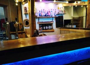 a bar with a wooden counter top in a room at Les chalets du Relais d'Aguilar in Tuchan