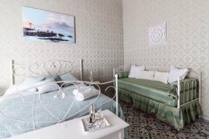 a small bedroom with two beds and a table at Casa Maia in Naples