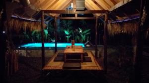 a room with a swimming pool and a wooden table at Seacroft Bamboo Village in Hinkong