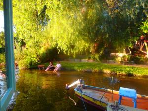 two people sitting on a boat in a river at Drijfpaleis in Arnhem