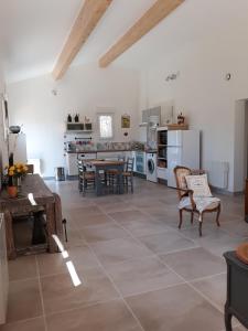 a large kitchen and dining room with a table and chairs at Galinette in Peypin