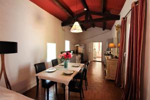 a dining room with a table with flowers on it at Villa de Charme sur la Corniche in Sète