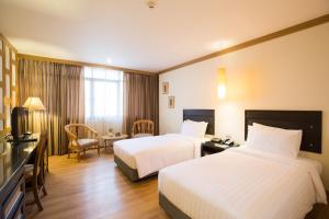Postel nebo postele na pokoji v ubytování The Tarntawan Hotel Surawong Bangkok