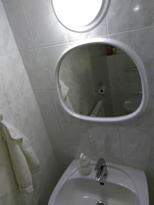 a white bathroom with a sink and a mirror at PENSION KUBU Apartment 3 samostatný byt s kuchyní in Špindlerův Mlýn