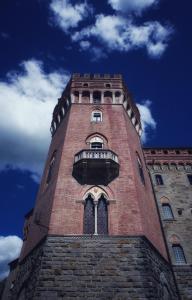 a very tall clock tower with a clock on it's side at Castello di Valenzano in Arezzo