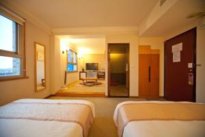 Rúm í herbergi á Tian Long Hotel