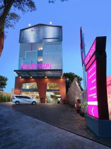 a building with a car parked in front of it at favehotel Malang in Malang