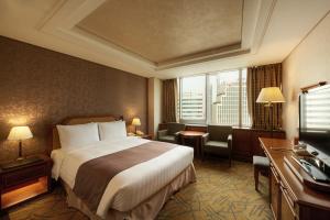 a hotel room with a large bed and a large window at Seoul Riviera Hotel in Seoul
