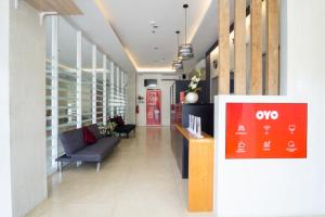 a lobby of a building with a couch and chairs at 18 Suites Cebu in Cebu City