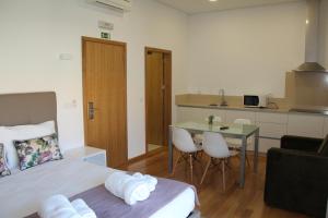 um quarto com uma cama e uma mesa e uma cozinha em Hotel Rural da Freita em Arouca