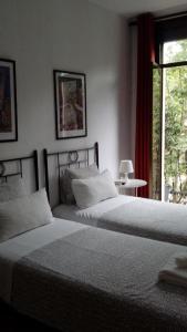 a hotel room with two beds and two lamps at Hostal Absolut Stay in Barcelona