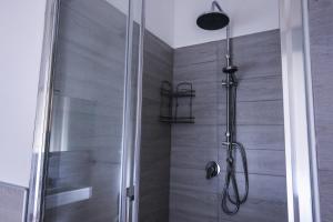 a shower stall with a glass door in a bathroom at MarioHome in Sassari