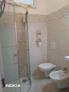 a bathroom with a shower and a toilet and a sink at Castellaneta Short Term -Low cost in Castellaneta