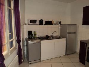 a small kitchen with a sink and a refrigerator at Collioure in Collioure