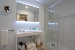 a bathroom with a sink and a shower at Soller Plaza in Sóller