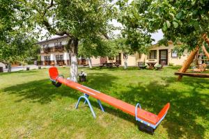a playground with a slide in a yard at Vila Tante in Šventoji