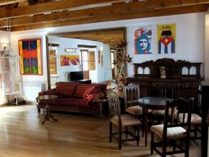 a living room with a couch and a table and chairs at Pensión Alfin in Granada
