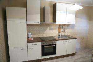 a kitchen with white cabinets and a sink at Apartment 51 in Gornji Karin