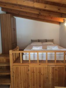 a large bed in a room with wooden walls at Panorama Thea in Symi