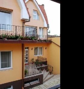 a large building with balconies and a courtyard at Pensiunea Phoenix in Oradea